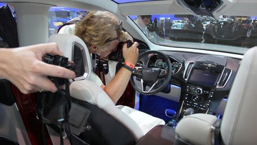 People view the interior of a Ford Edge concept vehicle during media preview days at the 2013 Los Angeles Auto Show.