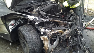 In this photo provided by the Tennessee Highway Patrol, emergency workers respond to a fire on a Tesla Model S electric car in Smyrna, Tenn. Spokeswoman Liz Jarvis Shean says Tesla has sent a team to Tennessee to investigate the fire.