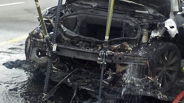 In this photo provided by the Tennessee Highway Patrol, emergency workers respond to a fire on a Tesla Model S electric car in Smyrna, Tenn. Spokeswoman Liz Jarvis Shean says Tesla has sent a team to Tennessee to investigate the fire.