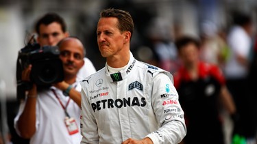 Michael Schumacher of Germany and Mercedes GP walks back to the pits after crashing out during practice for the Hungarian Formula One Grand Prix in Budapest, Hungary.