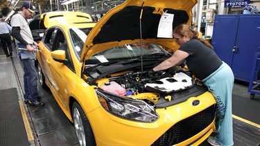 Ford workers assemble a Ford Focus ST at the Michigan Assembly Plant in Wayne, Michigan. The plant is the only one in the world that builds vehicles with five different fuel efficient powertrains on the same line.