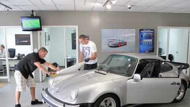 Jaren Baranyay, at left, and Leo Hinojosa work for Protex Calgary South, operated by Refine Automotive Salon. They are working 'mobile' in this shot at Tunerworks, a local high-end aftermarket parts supply and tuning shop.