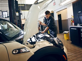 Ryan Griffith, a mechanic at Mini Downtown in Toronto, works on Mini. Some things are better left to the pros.