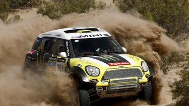 Mini driver Joan "Nani" Roma of Spain and co-pilot Michel Perin of France race during the fifth stage of the Dakar Rally between the cities of Chilecito and San MIguel de Tucuman, Argentina, Thursday, Jan. 9, 2014.