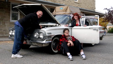 Steve Pasztor, his wife Deirdre and his son Kaeluis Bruce-Pasztor with their pooch Del Ray, named after a 1958 Chevrolet, with their 1960 Chevrolet Nomad at the Alberta Ballet building.