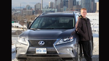 John Morrison stands alongside the 2014 Lexus RX450h Hybrid he has test driven.