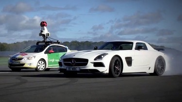 Top Gear's Stig, driving a white Mercedes-Benz SLS AMG, runs donuts around Google's Street View car.