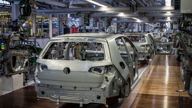 Bare metal chassis of seventh-generation Golfs move slowly down the line. Production is underway, but still in a testing mode.