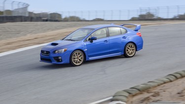 Driving's David Booth finds out if the 2015 Subaru WRX STI can hold its own with a lap around Mazda Raceway Laguna Seca.