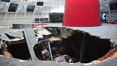 In this image provided by the National Corvette Museum shows several cars that collapsed into a sinkhole Wednesday, Feb. 12, 2014, in Bowling Green, Ky. The museum said a total of eight cars were damaged when a sinkhole opened up early Wednesday morning inside the museum.