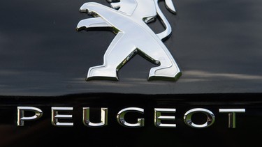 The Peugeot logo is seen on a new Peugeot 308. Chinese automaker Donfeng Motor recently acquired a stake in the French automaker for 800 million euro.