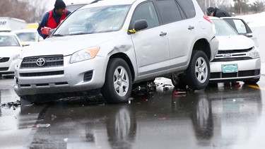 A Salvation Army worker passes out food to drivers whose vehicles were piled up in an accident, Friday, Feb. 14, 2014, in Bensalem, Pa.