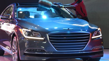 A worker cleans a 2015 Hyundai Genisis at the 2014 New Yrok Auto Show April 16, 2014 at the Jacob Javits Center in New York. The auto show opens to the public on April 18, and runs through the 27th.