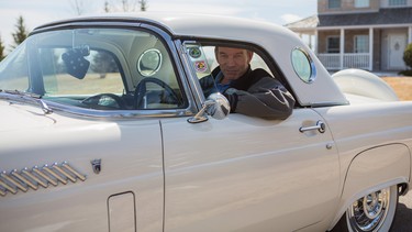 John Moore sits behind the wheel of his 1956 Ford Thunderbird at his home in Bearspaw, Alta.