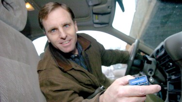 In this 2006 file photo, Adam Gordon, of Saint Paul, Minnesota, displays the wireless device that his auto insurance provider uses to monitor his driving speed, distance, braking and accelerating, and what time he's driving. In exchange, Gordon gets a 15% savings on his auto insurance premiums.