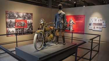 The machine is a 1920 J-model Harley-Davidson, and the garb is indicative of what an early motorcyclist would have worn.