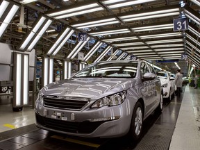 A view of a new Peugeot 308 car by French car maker PSA Peugeot Citroen on an assembly line at the company's factory in France.