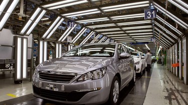 A view of a new Peugeot 308 car by French car maker PSA Peugeot Citroen on an assembly line at the company's factory in France.