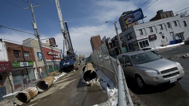 Traffic moves past closed lanes at the corner of Eglinton Avenue and Dufferin Street in Toronto.