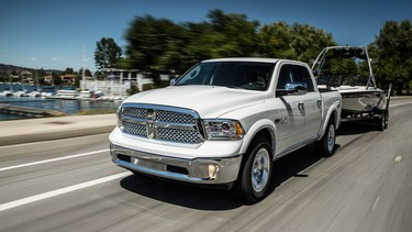 2014 Ram 1500 Laramie Crew Cab 4X4 with a properly secured boat in tow.