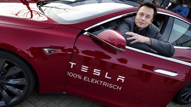 Elon Musk, co-founder and CEO of American electric vehicle manufacturer Tesla Motors, poses with a Tesla