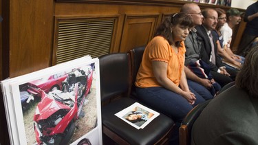 Family members of victims resulting from problems with GM ignition switches sit alongside their loved ones photographs as General Motors CEO Mary Barra and Anton Valukas, head of GM's internal recall investigation, testify on the GM ignition switch recall during a US House Oversight and Investigations Subcommittee hearing on Capitol Hill in Washington, DC, June 18, 2014.