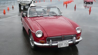 1969 MGB owner Doug Gale sits in the passenger seat as a young driver shifts through the gears at the Hagerty Driving Experience event in Pitt Meadows.