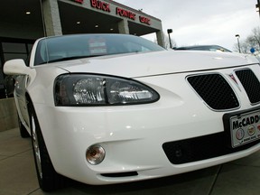 An unsold 2006 Grand Prix sedan sits outside a General Motors dealership in Boulder, Colo. in this 2007 file photo. General Motors’ safety crisis worsened on Monday, June 30, 2014, when the automaker added 8.2 million vehicles to its huge list of cars recalled over faulty ignition switches.