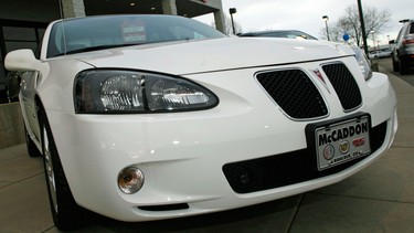 An unsold 2006 Grand Prix sedan sits outside a General Motors dealership in Boulder, Colo. in this 2007 file photo. General Motors’ safety crisis worsened on Monday, June 30, 2014, when the automaker added 8.2 million vehicles to its huge list of cars recalled over faulty ignition switches.