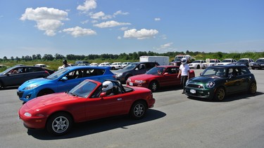 An assortment of makes and models are present to participate in various car control exercises.