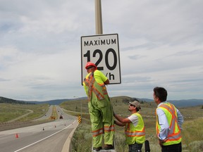 B.C. transportation ministry crews change the speed limit signs on July 2, 2014, in Kamloops, B.C. By 2016, a third of the raised speed limits were rolled back.