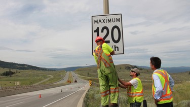 B.C. transportation ministry crews change the speed limit signs on July 2, 2014, in Kamloops, B.C. By 2016, a third of the raised speed limits were rolled back.