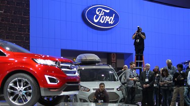 People watch a presentation of the Ford Edge concept vehicle during media preview days at the 2013 Los Angeles Auto Show. 30 world premieres are scheduled for this year's show.