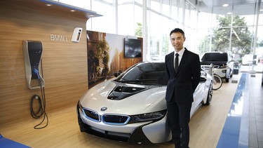 Brian Jessel BMW ‘i Product Genius’ Jorge Su stands with a BMW i8 in the Vancouver dealership’s all-new BMW i Brand Centre.