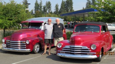 John Stirling and his Langley friend Dale McKinstry stand with their 1947 Chevs during a tour stop.