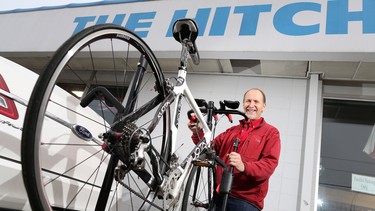 Bob Gardner with the Hitch Shop in Calgary stands with a hitch mount bicycle rack.