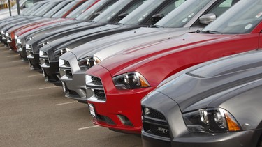 In this file photo, a line of unsold Chargers sits at a Dodge dealership in Colorado.