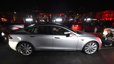 Drivers test the new Tesla 'D' model which is a faster and all-wheel-drive version of the Model S electric sedan at the Hawthorne Airport in Los Angeles on October 9, 2014.