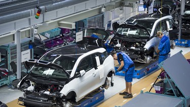 Workers assemble a new BMW i3 electric car on the assembly line at the BMW factory in Leipzig, Germany. BMW will, however, be opening a factory in Mexico soon.