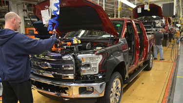 A Ford employee helps assemble the all-new, aluminum-bodied F-150 pickup.