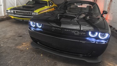 A 2015 Dodge Challenger SRT Hellcat with its predecessor.