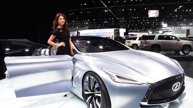 A model poses beside the Infiniti Q80 Inspiration concept vehicle on display at the LA Auto Show's press and trade day in Los Angeles, Calif. on Nov. 20, 2014.