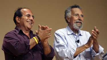 In this June 19, 2008 photo, brothers Ray, left, and Tom Magliozzi, co-hosts of National Public Radio's "Car Talk" show, applaud during a premier of a cartoon show about them in Cambridge, Mass. NPR says Tom Magliozzi died Monday, Nov. 3, 2014 of complications from Alzheimer's disease. He was 77.