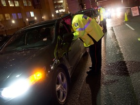 Police officers stop motorists during a RIDE program spot-check on Lake Shore Blvd. in Toronto, Thursday, Dec. 13, 2012.