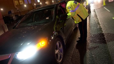 Police officers stop motorists during a RIDE program spot-check on Lake Shore Blvd. in Toronto, Thursday, Dec. 13, 2012.