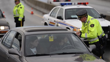 An RCMP officer stops a car as part of the CounterAttack program in B.C.