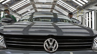 Employees do a quality inspection on a Volkswagen AG Jetta vehicle at the company's assembly plant in Puebla, Mexico