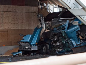 A bread truck was crushed after a dump truck collided into scaffolding  on the Burlington Skyway bridge in Burlington, Ont., Friday, August 1, 2014. A 34-year-old Brampton man was charged with impaired driving in connection with the crash that occurred on July 31.