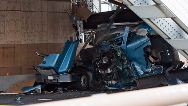 A bread truck was crushed after a dump truck collided into scaffolding  on the Burlington Skyway bridge in Burlington, Ont., Friday, August 1, 2014. A 34-year-old Brampton man was charged with impaired driving in connection with the crash that occurred on July 31.