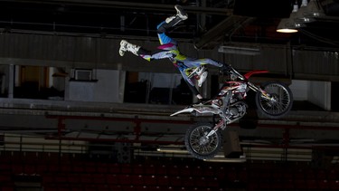 FMX rider Billy Kohut looks like he's hanging on for life, but is just performing another trick. He's part of the Extreme Thrills show at the Calgary Motorcycle Show.